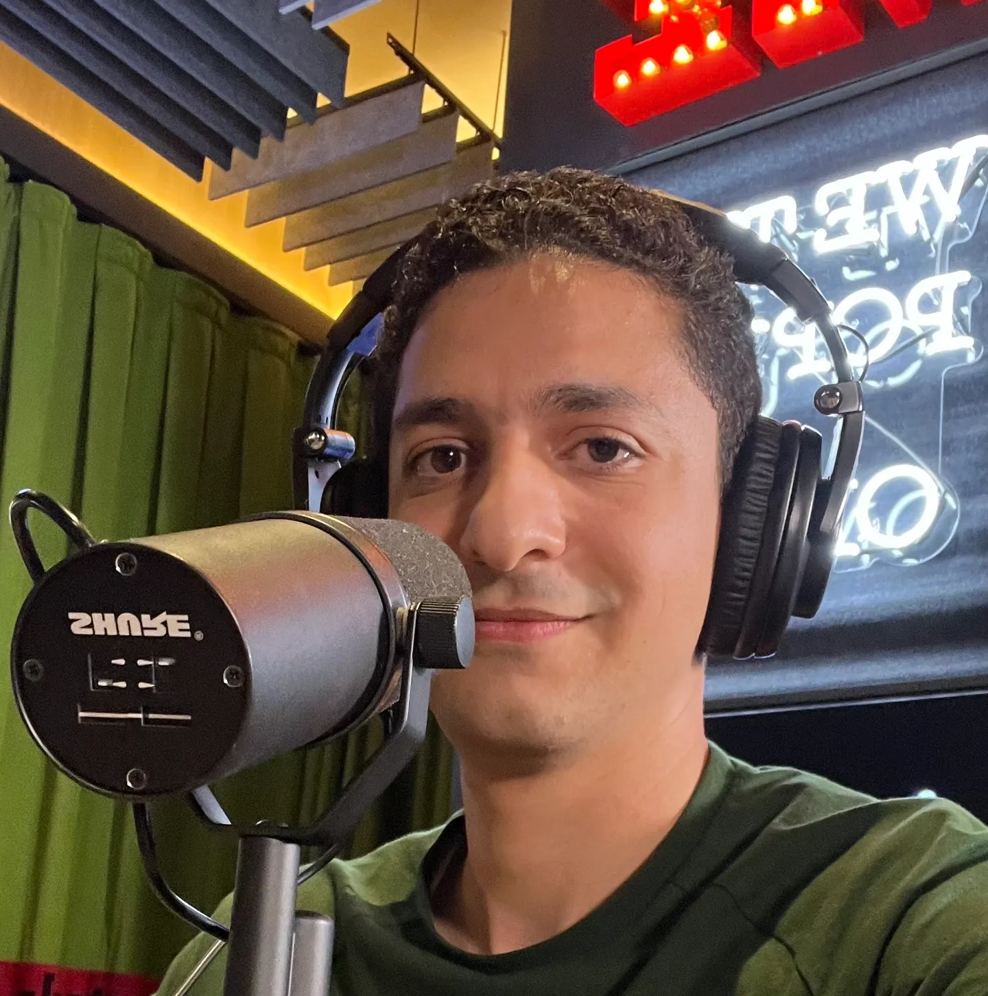 Abdelrahman Ismail speaking into a studio microphone